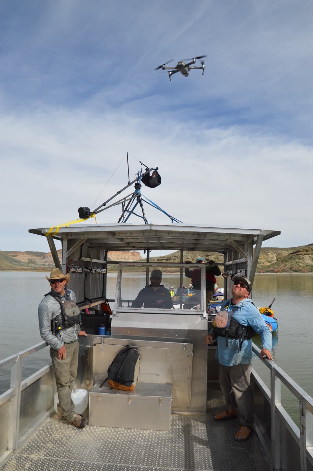 USGS drone with LiDAR sensor flying above scientists conducting field survey from a boat
